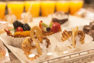 a plate of food with fruit on a table at Kawada Hotel in Los Angeles