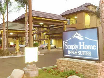 a sign for a small home inn and suites at Simply Home Inn & Suites - Riverside in Riverside