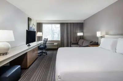 a hotel room with a large bed and a desk at Hilton Garden Inn Bakersfield in Bakersfield
