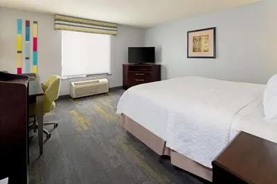 a hotel room with a bed and a desk and a window at Hampton Inn and Suites Bakersfield / Highway 58 in Bakersfield