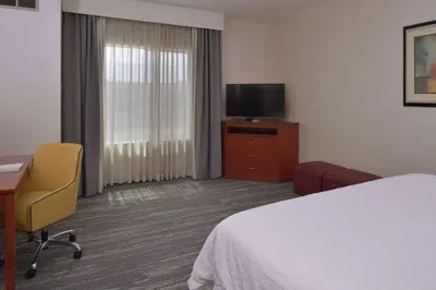 a hotel room with a bed and a desk and a television at Hampton Inn and Suites Bakersfield North-Airport in Bakersfield