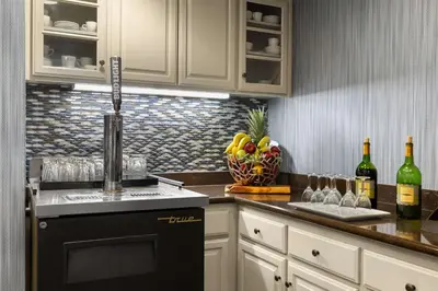 a kitchen with a counter with bottles of wine at Homewood Suites Bakersfield in Bakersfield