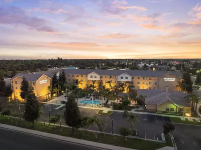 an aerial view of a building at sunset at Homewood Suites Bakersfield in Bakersfield