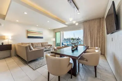 a living room with a table and chairs and a couch at Shade Hotel Redondo Beach in Redondo Beach