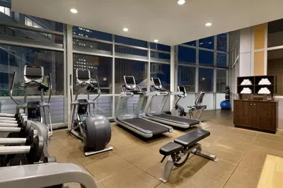 a gym with treadmills and machines in a building at Embassy Suites Los Angeles Glendale in Glendale