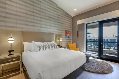 a bedroom with a large bed and a large window at Bluestem Hotel Torrance Los Angeles, an Ascend Collection Hotel in Torrance