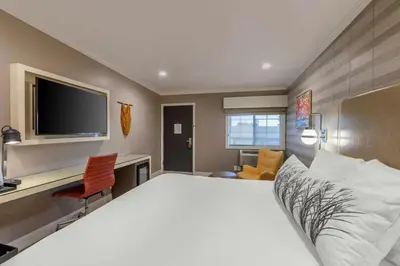 a bedroom with a bed and a desk and a tv at Bluestem Hotel Torrance Los Angeles, an Ascend Collection Hotel in Torrance