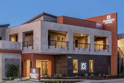 a building with a sign in front of it at Bluestem Hotel Torrance Los Angeles, an Ascend Collection Hotel in Torrance