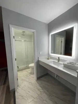 a bathroom with a sink and a toilet and a mirror at Casa Bell Motel, Los Angeles - LAX Airport in Inglewood