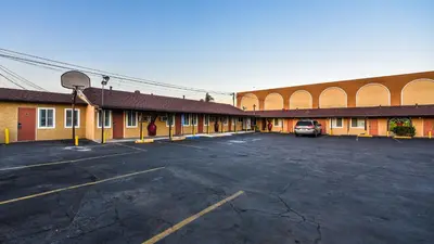 an empty parking lot in front of a building at Casa Bell Motel, Los Angeles - LAX Airport in Inglewood