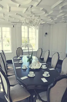 a dining room with a black table and chairs at The Culver Hotel in Los Angeles