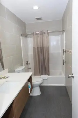 a bathroom with a toilet and a shower at Value Inn Bellflower in Bellflower