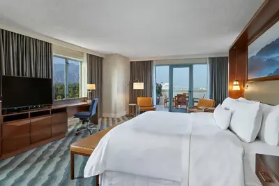 a hotel room with a large bed and a flat screen tv at The Westin Pasadena in Pasadena