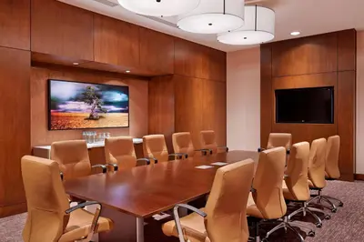 a conference room with a wooden table and chairs at The Westin Pasadena in Pasadena