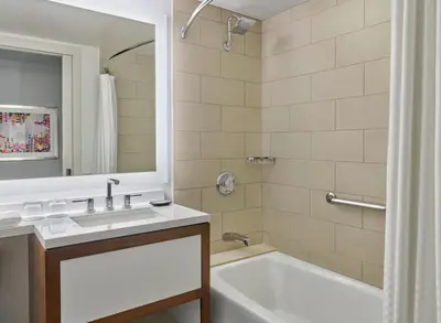 a bathroom with a white tub and a sink and a bath tubermott at The Westin Pasadena in Pasadena