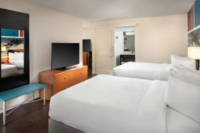 a hotel room with two beds and a flat screen tv at Fairfield by Marriott Anaheim Resort in Anaheim