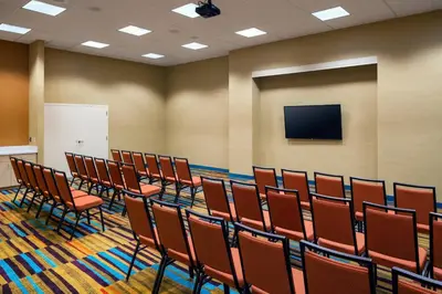 a conference room with chairs and a flat screen tv at Fairfield by Marriott Anaheim Resort in Anaheim