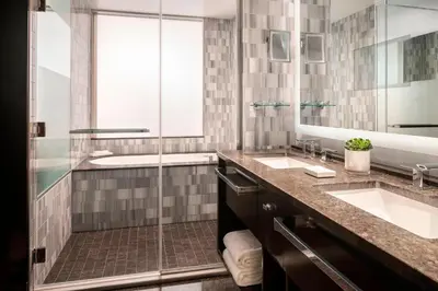a bathroom with two sinks and a shower at The Ritz-Carlton, Los Angeles L.A. Live in Los Angeles
