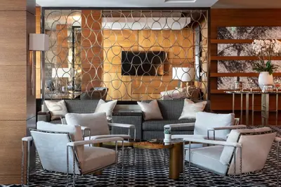 a lobby with a couch and chairs and a fireplace at The Ritz-Carlton, Los Angeles L.A. Live in Los Angeles
