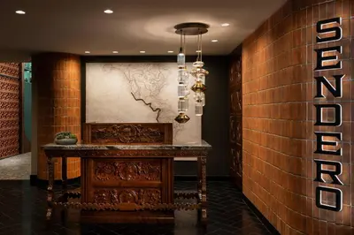 a lobby with a wooden table and a wall at The Ritz-Carlton, Los Angeles L.A. Live in Los Angeles