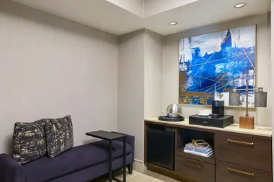 a living room with a couch and a painting on the wall at Renaissance Los Angeles Airport Hotel in Los Angeles