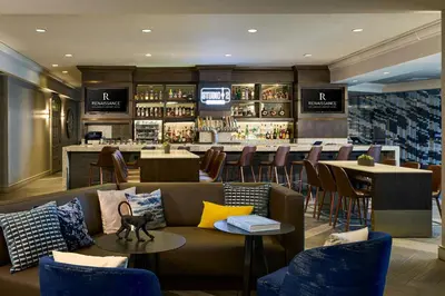 a restaurant with a couch and a bar at Renaissance Los Angeles Airport Hotel in Los Angeles