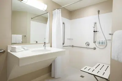 a white bathroom with a sink and a shower at SpringHill Suites Los Angeles LAX/Manhattan Beach in Hawthorne