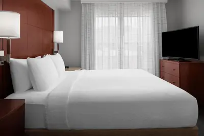 a bedroom with a large white bed and a television at Residence Inn Los Angeles Burbank/Downtown in Burbank