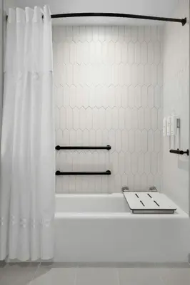 a white bathroom with a tub and a shower curtain at Marina del Rey Marriott in Los Angeles
