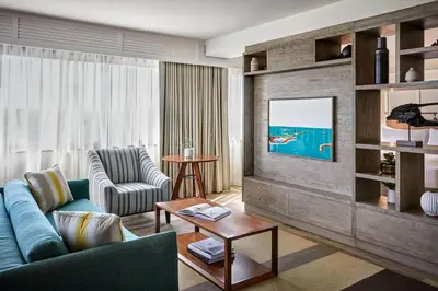 a living room with a blue couch and a table at Westdrift Manhattan Beach, Autograph Collection in Manhattan Beach
