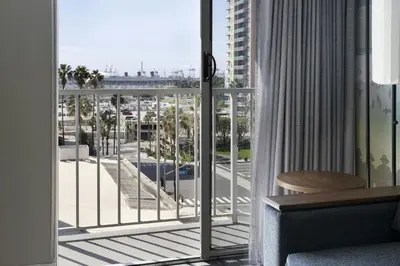 a room with a balcony with a view of a street at Courtyard by Marriott Long Beach Downtown in Long Beach