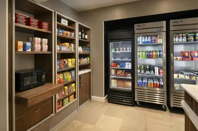 a kitchen with two large refrigerators and a refrigerator at Courtyard by Marriott Long Beach Downtown in Long Beach