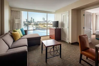 a living room with a couch and a room with a view at Residence Inn Long Beach Downtown in Long Beach