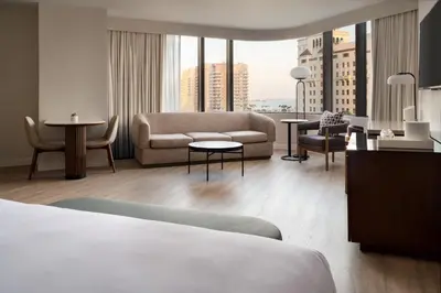 a hotel room with a bed and a couch at Marriott Long Beach Downtown in Long Beach
