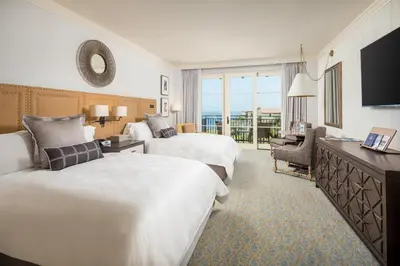 a hotel room with two beds and a television at Terranea Resort in Rancho Palos Verdes