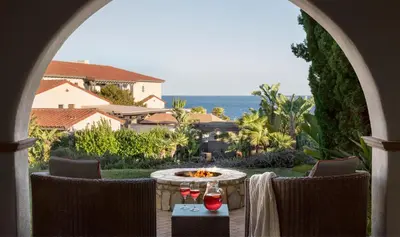 a patio with a table with two wine glasses at Terranea Resort in Rancho Palos Verdes