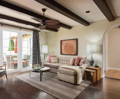 a living room with a couch and a ceiling fan at Terranea Resort in Rancho Palos Verdes