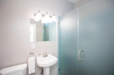 a white bathroom with a sink and a shower at Ocean Park Hotel in Los Angeles