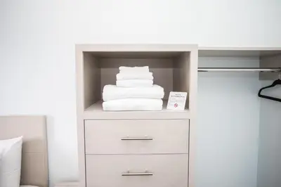 a stack of towels on a shelf in a bedroom at Ocean Park Hotel in Los Angeles