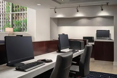 an office with two computer monitors on a desk at Courtyard Los Angeles Century City/Beverly Hills in Los Angeles