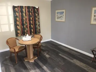 a room with a table and chairs and a window at Galleria Inn Montclair/Ontario in Montclair