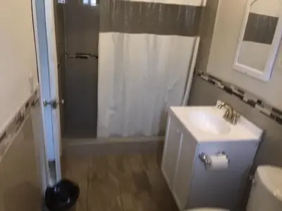 a bathroom with a shower and a sink and a toilet at Galleria Inn Montclair/Ontario in Montclair