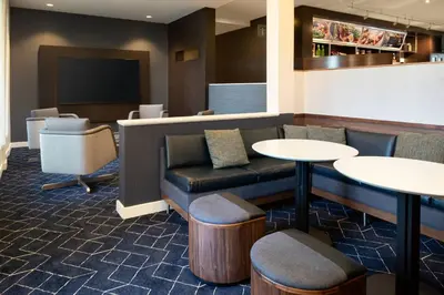 a waiting room with two tables and a couch at Courtyard by Marriott Bakersfield in Bakersfield