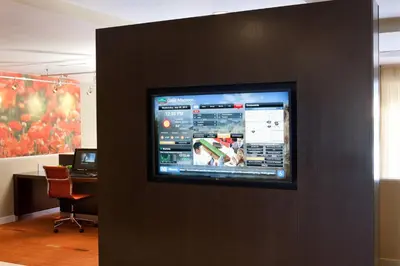 a flat screen tv on a wall in an office at Courtyard by Marriott Bakersfield in Bakersfield