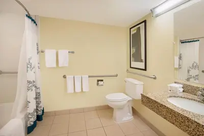 a bathroom with a toilet and a sink and a shower at Residence Inn Bakersfield in Bakersfield