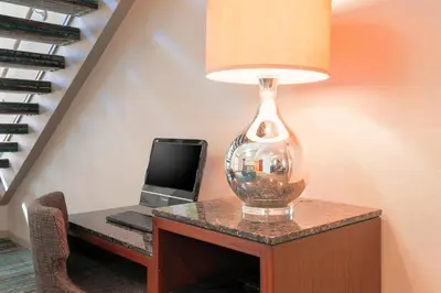 a glass lamp sitting on a table with a laptop at Residence Inn Bakersfield in Bakersfield