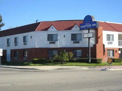 a building with a street sign in front of it at Palms Courtyard Inn in Westminster