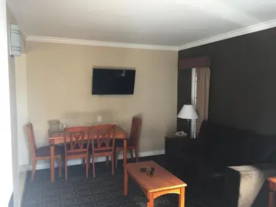 a living room with a table and a couch at Seaside Motel in Redondo Beach