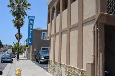 a building with a sign on the side of a street at Seaside Motel in Redondo Beach