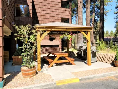 a picnic shelter with a picnic table in a backyard at Snow Lake Lodge in Big Bear Lake